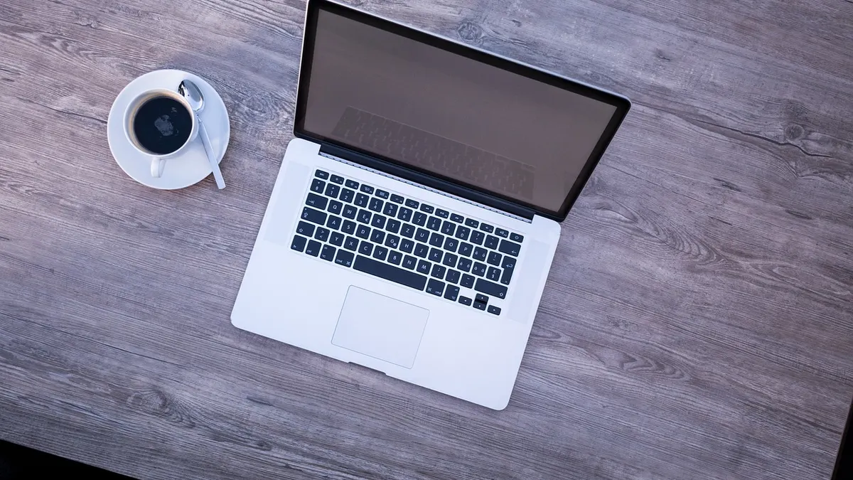 Laptop z otwartym projektem graficznym i plikami wektorowymi