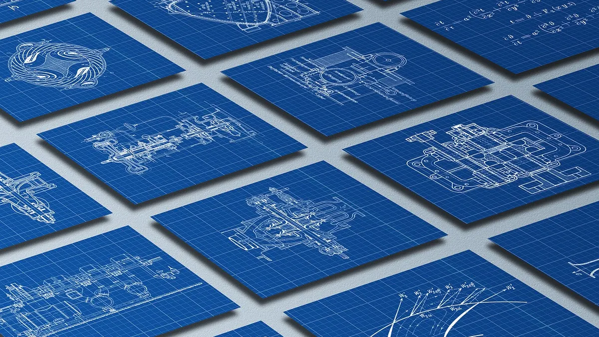 Laptop z technicznym rysunkiem CAD i planami budowlanymi